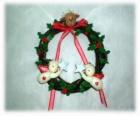 Guirlanda de Natal decorada com folhas de azevinho um chefe de uma rena, dois anjos e um laço vermelho