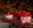 Velas de Natal iluminada e decorada com frutos vermelhos
